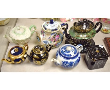 A Belleek nautilus shell teapot and cover, printed mark in black; a Losol Ware Argyll pattern teapot and cover; others Booth'