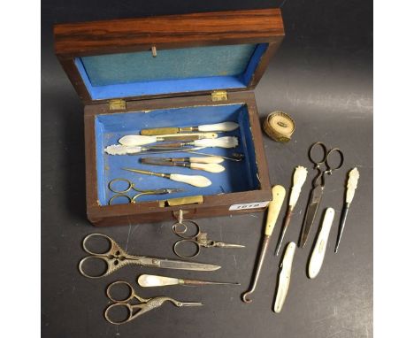 A Victorian Rosewood sewing box, containing mother of pearl handled sewing picks, scissors, folding knives; etc.; qty