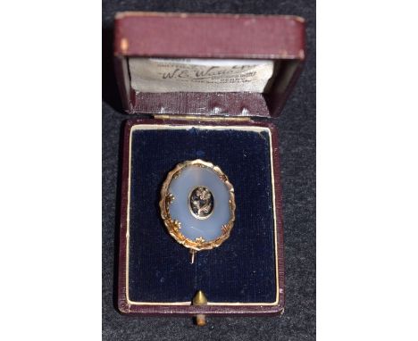 A Victorian gold framed milky agate brooch, centre with diamond set flower on enamel panel, boxed
