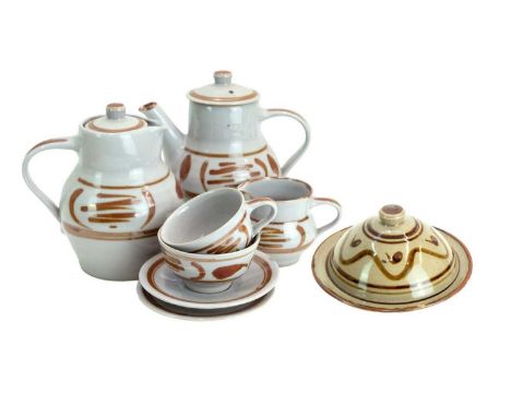 Crowan Pottery A collection of eight pieces  Including a milk jug, butter dish, sugar bowl, one cup, two saucers, tea pot and