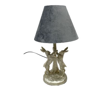 Silvered effect composite table lamp, modelled as a pair of boxing hares, with a grey velvet shade, H45cmDimensions: Height:&