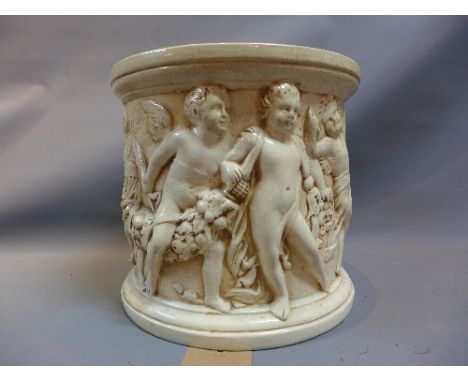 A Bretby white glazed ceramic jardiniere, decorated with a continuous procession of putti, marked to base, H. 28cm