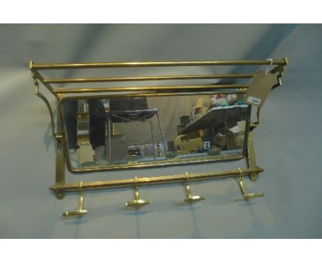 An early 20th Century brass mirrored back coat rack