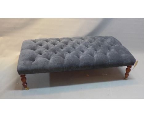 A Victorian style stool with blue velour button down upholstery, raised on turned legs and castors, H. 33cm W. 123cm D. 64cm