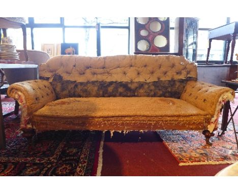 A Victorian Howard & Son style three seater sofa raised on turned mahogany feet and castors (a/f)