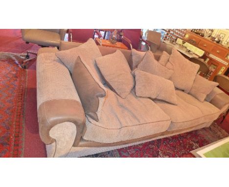 A contemporary three seater sofa with corduroy and part leather upholstery