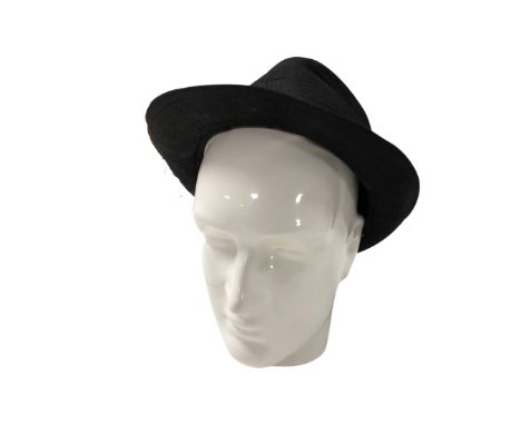 A ceramic mannequin head together with a hat