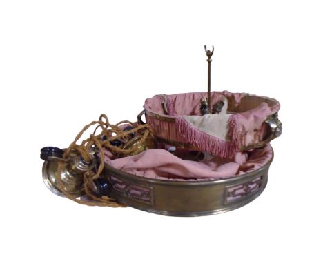 An antique brass rise and fall light fitting upholstered in fabric 