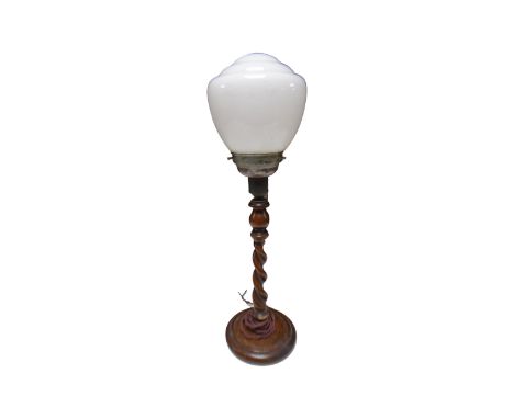 An oak barley twist table lamp with opaque glass shade.