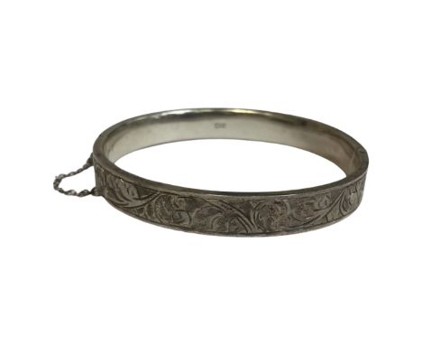 A silver bangle with safety chain, Chester 1952, 12.9g.