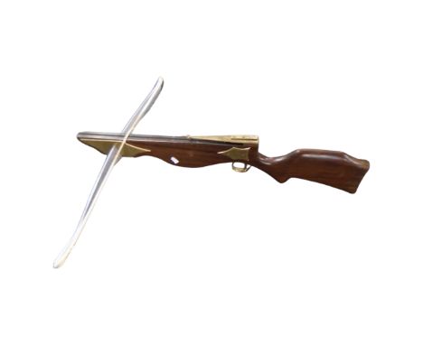 A mahogany and brass crossbow 