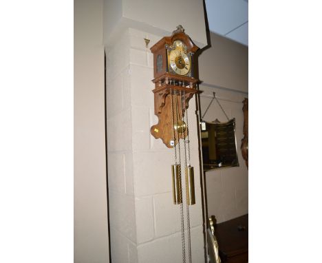 A modern Dutch style wall clock in oak case, the ornate arched silvered roman dial flanked by corinthian style columns, mount