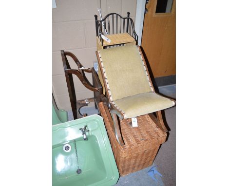 A rocking footstool; a picnic basket; a wrought iron and cane-work shelf unit; and a stick stand.