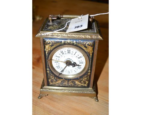 A 19th Century French alarm clock in ebonised and brass case (distressed).