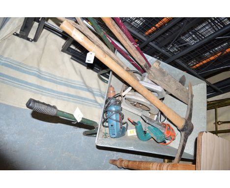 Three electric power tools; garden tools; and a wheelbarrow.
