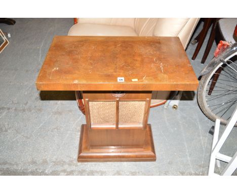 An Art Deco walnut veneered rectangular occasional table, fitted as a wireless speaker and raised on plinth base.