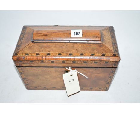 A 19th Century inlaid walnut sarcophagus-shaped tea caddy, the shaped top opening to reveal and interior of two compartments 