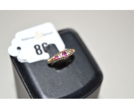 A ruby and diamond ring, set two diamonds and two rubies (one ruby missing), on an 18ct. shank.