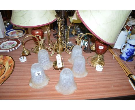 A electric five branch centre ceiling light fitting in brass with glass shade; and four modern electric table lamps, various.