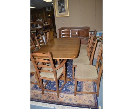 A twelve-piece light stained elm dining suite, comprising: a sideboard with four central drawers flanked by cupboards, an ext