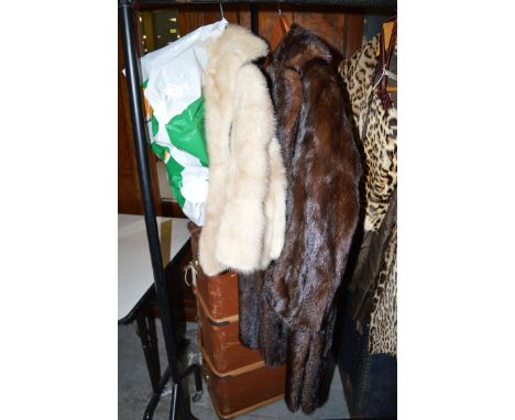 A dark mink coat by Marcus of London, with patterned lining; together with a light coloured mink stole; and two fur hats in a
