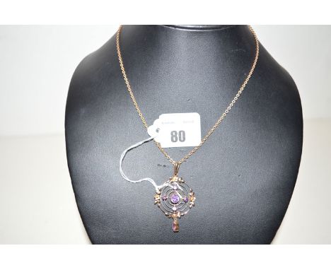 An Edwardian amethyst set floral decorated target pattern pendant on chain.