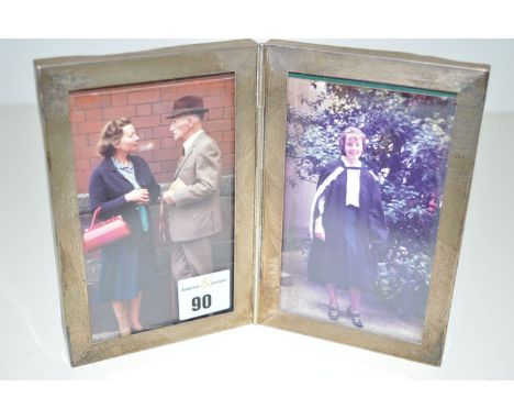 A double-sided silver mounted picture frame with engine turned decoration, by Samuel & McKenzie, Birmingham 1976.