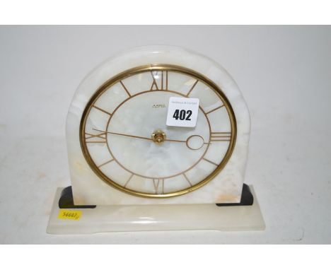 An Art Deco style alabaster mantel clock, fitted a later quartz movement.