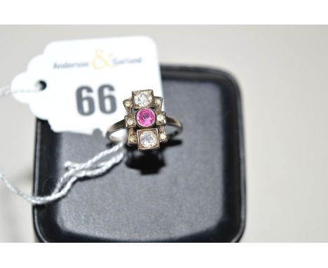 A ruby and diamond Art Deco ring, the circular facet cut ruby flanked above and below by old old cut diamonds, smaller senail