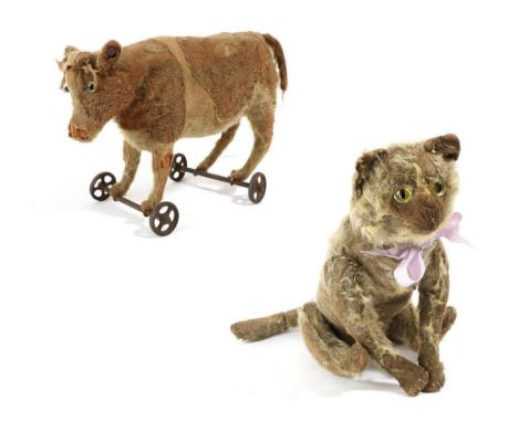 Circa 1910 Steiff mohair jointed cat, with stitched paws and mouth, 35cm long; together with a circa 1908 Steiff mohair oxen 