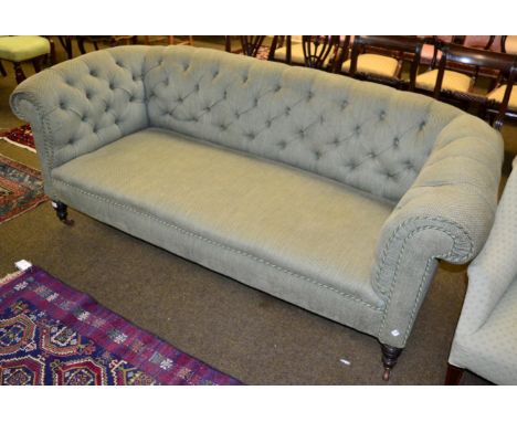 A light green Victorian Chesterfield sofa 