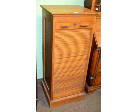 A light oak stationary cabinet with sliding front and applied plaque stamped 'Boots Business Systems'