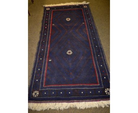 Balouch Rug, Persian/Afghan Frontier, the walnut field of hooped diamonds enclosed by latch hook gul borders, 213cm by 109cm 