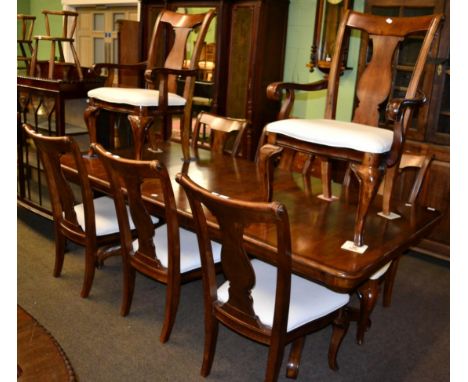 A reproduction mahogany extending dining table in the William IV style together with a matching set of eight dining chairs in