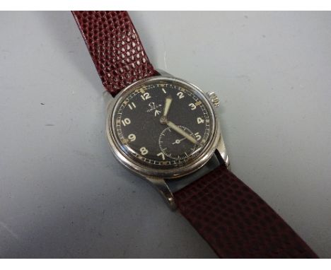 AN OMEGA FIFTEEN JEWEL BRITISH MILITARY GENTLEMANS WRISTWATCH, the black face with subsidiary seconds dial, ministry broad ar