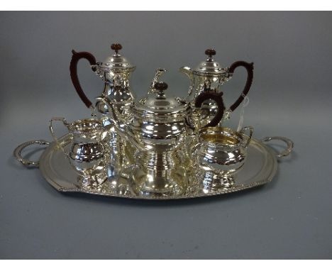 A MATCHED SILVER SIX PIECE TEA SERVICE, of squat form with floral beading, comprising teapot, milk jug, sugar bowl (dented), 