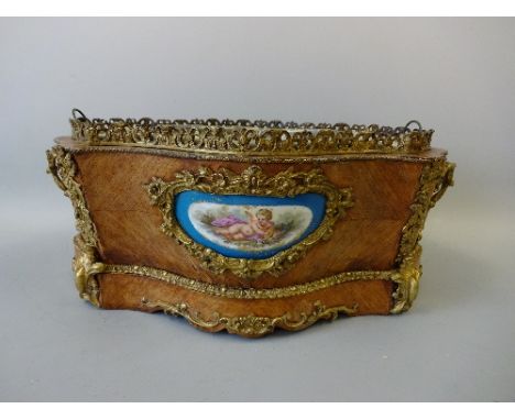 A FRENCH LOUIS XVI STYLE PLANTER, of lobed oval form with ormolu gallery, carrying handles, apron and floral cartouches conta