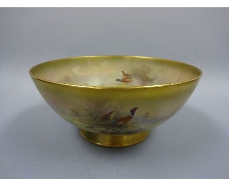 A ROYAL WORCESTER BOWL, decorated to both interior and exterior with Pheasants in landscape, gilt rim and foot, signed Jas St