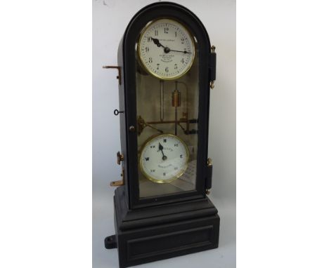 A CAST IRON FACTORY CLOCK, with arched top over circular white enamelled dial with Arabic numerals inscribed W H Bailey & Co 