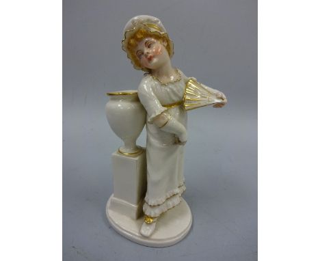 A ROYAL WORCESTER FIGURE, girl standing before urn holding fan, modelled by James Hadley in Kate Greenaway style, in white en