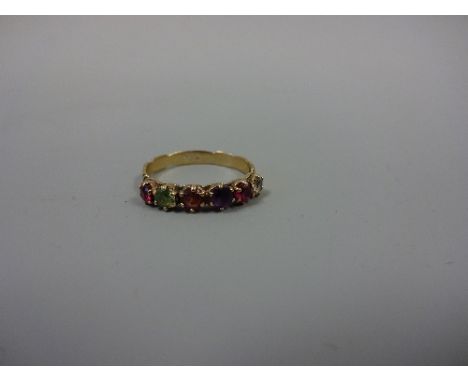 A VICTORIAN 'REGARD' RING, with ruby, emerald, garnet, amethyst coloured paste stones to the decorative scrolling band, stamp