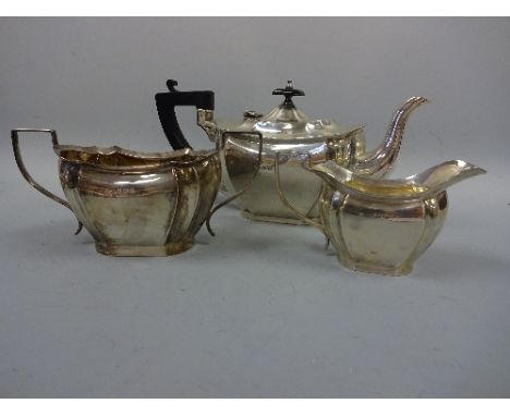 A SILVER ART DECO THREE PIECE TEA SERVICE, teapot with ebonised handle and finial, Birmingham 1931, total weight approximatel