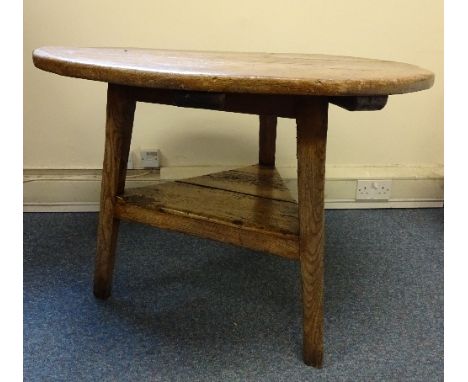 A 19TH CENTURY CRICKET TABLE, of typical form, the circular pine top over elm supports with triangular stretcher shelf, appro