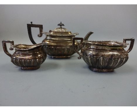 A MATCHED SILVER THREE PIECE TEA SERVICE, half reeded with moulded border, teapot with ebonised handle and finial, teapot and
