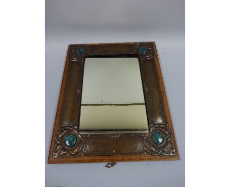 AN ART NOUVEAU BEATEN COPPER RECTANGULAR EASEL MIRROR, with stylised floral corner detail with Ruskin style turquoise colour 