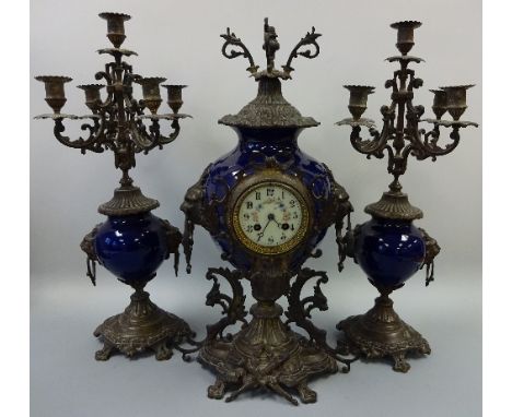 A 19TH CENTURY STYLE COBALT CERAMIC CLOCK GARNITURE, the urn shape clock with ormolu mounts to include griffin supports to sh