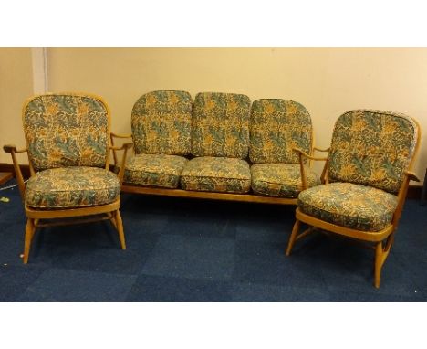 A BLONDE BEECH ERCOL THREE PIECE COTTAGE SUITE, comprising stick and hoop back settee and two armchairs, all upholstered in W