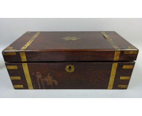 A VICTORIAN BRASS BOUND WRITING SLOPE, brass escutcheons, red velvet lifting writing surface fitted pen and accessory wells, 