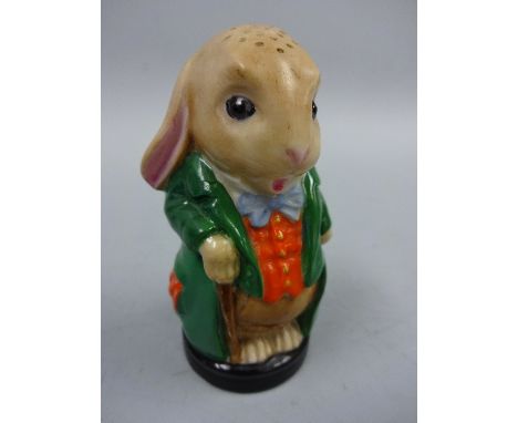 A ROYAL WORCESTER PEPPER POT, in the form of anthropomorphic rabbit, Mad Hatter ? on circular black plinth base, puce marks t