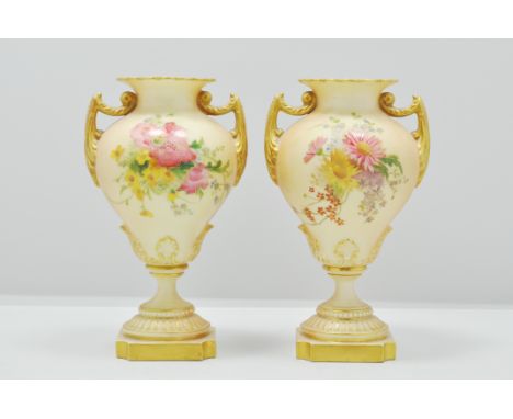 Pair of Royal Worcester urn shaped vases, circa 1900, floral decoration on a blush ground, 15cms.